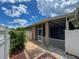 Enclosed porch surrounded by garden features a paved path leading to a white picket fence at 12200 Hunters Lake Dr, New Port Richey, FL 34654