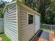 Exterior view of outdoor shed, with horizontal siding, a window and door at 12200 Hunters Lake Dr, New Port Richey, FL 34654