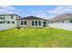 Backyard view showcases the rear of the home and a spacious lawn area at 12322 Eagle Swoop Pl, Riverview, FL 33579