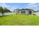 Spacious backyard with a green lawn, privacy fence, and rear home elevation at 12322 Eagle Swoop Pl, Riverview, FL 33579