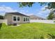 The well-manicured backyard features a green lawn and the home's rear elevation at 12322 Eagle Swoop Pl, Riverview, FL 33579