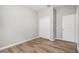 Empty bedroom with wood-style flooring and closet space for ample storage options at 12322 Eagle Swoop Pl, Riverview, FL 33579