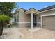 Inviting front entrance with stone accents, a covered porch, and manicured landscaping at 12322 Eagle Swoop Pl, Riverview, FL 33579