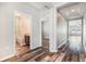 Bright hallway featuring hard surface floors, a trey ceiling, and views into the bathroom and living area at 12322 Eagle Swoop Pl, Riverview, FL 33579