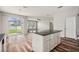 Open kitchen featuring dark granite countertops and a view into the backyard through sliding glass doors at 12322 Eagle Swoop Pl, Riverview, FL 33579