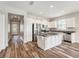 Modern kitchen with white cabinets, stainless steel appliances, and dark countertops at 12322 Eagle Swoop Pl, Riverview, FL 33579