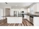 Bright kitchen with stainless appliances, white cabinetry, and an island with dark countertops at 12322 Eagle Swoop Pl, Riverview, FL 33579