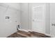 Small laundry room with white walls, wood-look flooring and wire shelving at 12322 Eagle Swoop Pl, Riverview, FL 33579