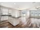 Modern kitchen with island open to the living area, featuring stainless steel appliances and hard surface floors at 12322 Eagle Swoop Pl, Riverview, FL 33579