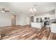 Open-concept living space featuring hard surface floors and a modern kitchen with stainless steel appliances at 12322 Eagle Swoop Pl, Riverview, FL 33579