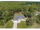 Aerial view of property showing the house nestled in a serene, heavily wooded area at 12333 Harris Hawk Rd, Weeki Wachee, FL 34614