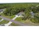 An aerial view showcasing a home with manicured lawns and mature trees in a verdant setting at 12333 Harris Hawk Rd, Weeki Wachee, FL 34614