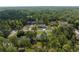 Wide aerial view of a neighborhood surrounded by trees, highlighting the home's location at 12333 Harris Hawk Rd, Weeki Wachee, FL 34614