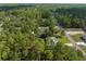 Aerial shot showcases a charming house surrounded by a dense, vibrant forest landscape at 12333 Harris Hawk Rd, Weeki Wachee, FL 34614