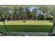 Expansive backyard view from patio, featuring lush lawn and privacy fence at 12333 Harris Hawk Rd, Weeki Wachee, FL 34614