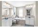 Luxurious bathroom features dual vanities, a soaking tub, and elegant fixtures, creating a spa-like experience at 12333 Harris Hawk Rd, Weeki Wachee, FL 34614