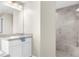 Modern bathroom with a walk-in shower featuring gray tiling and a white vanity at 12333 Harris Hawk Rd, Weeki Wachee, FL 34614