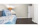 Comfortable bedroom featuring wood floors, a decorative lamp, and a convenient door at 12333 Harris Hawk Rd, Weeki Wachee, FL 34614