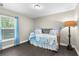 Cozy bedroom with hardwood floors, a bright window, and charming decor at 12333 Harris Hawk Rd, Weeki Wachee, FL 34614