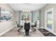 Elegant dining room boasts stylish chairs, a sleek table, and a view of the outdoor landscape at 12333 Harris Hawk Rd, Weeki Wachee, FL 34614