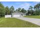 Charming single-story home with a two-car garage, manicured lawn, and a long driveway at 12333 Harris Hawk Rd, Weeki Wachee, FL 34614