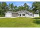 Charming single-story home with well-maintained lawn and attached two-car garage at 12333 Harris Hawk Rd, Weeki Wachee, FL 34614