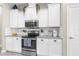 Modern kitchen featuring white cabinets, stainless steel appliances, and granite countertops at 12333 Harris Hawk Rd, Weeki Wachee, FL 34614
