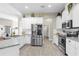 Bright kitchen featuring stainless steel appliances, subway tile backsplash, and light wood floors at 12333 Harris Hawk Rd, Weeki Wachee, FL 34614