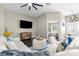 Open living area featuring sleek furnishings, a large TV, and views into adjacent rooms, creating an inviting space at 12333 Harris Hawk Rd, Weeki Wachee, FL 34614