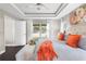 Serene main bedroom features a tray ceiling, plush bedding, and natural light from a large window at 12333 Harris Hawk Rd, Weeki Wachee, FL 34614
