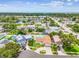 Aerial view showing the home and surrounding neighborhood including other homes, streets, and mature trees at 12476 81St Ct, Seminole, FL 33772