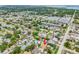 An aerial view of a home with a private pool in a verdant neighborhood, close to the water at 12476 81St Ct, Seminole, FL 33772