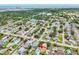 Aerial view of a residential neighborhood featuring the home with a pool, and partial water view at 12476 81St Ct, Seminole, FL 33772