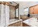 Charming bathroom with tiled shower, soaking tub, and vanity at 12476 81St Ct, Seminole, FL 33772