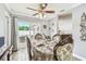 Cozy dining area featuring a decorative ceiling fan, wood-look tile, and sliding glass doors to backyard at 12476 81St Ct, Seminole, FL 33772
