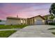 Charming single-story home with arched entryway, attached garage, and well-manicured lawn at 12476 81St Ct, Seminole, FL 33772