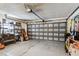 Spacious garage with storage shelves, work bench, and a metal garage door at 12476 81St Ct, Seminole, FL 33772