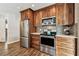 Updated kitchen showcasing stainless steel appliances, granite countertops, and decorative backsplash at 12476 81St Ct, Seminole, FL 33772