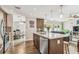 Open kitchen with a stainless steel appliances, center island, and wood-look tile flooring throughout at 12476 81St Ct, Seminole, FL 33772