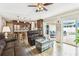 Open-concept living area with hardwood floors, stylish decor, and a view of the pool through sliding glass doors at 12476 81St Ct, Seminole, FL 33772