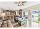 Spacious living room with an open concept layout with access to the kitchen and outdoor patio at 12476 81St Ct, Seminole, FL 33772