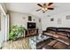 Comfortable living room with tile flooring, ceiling fan, television, and ample seating at 12476 81St Ct, Seminole, FL 33772