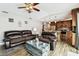 Comfortable living room featuring wood-look tile flooring, neutral walls, and a ceiling fan at 12476 81St Ct, Seminole, FL 33772