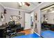 Office with black desk and chair, hardwood floors, a blue floor mat, and a view to the kitchen at 12476 81St Ct, Seminole, FL 33772