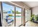Covered lanai view of beautiful outdoor living space, including a swimming pool with a jacuzzi, as seen through sliding glass doors at 12476 81St Ct, Seminole, FL 33772