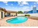 Inviting backyard oasis with a sparkling blue pool, spa, and brick paver patio at 12476 81St Ct, Seminole, FL 33772