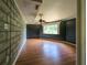 Bedroom with laminate floors, a painted brick accent wall, natural light from a window, ceiling fan at 12704 Lacey, New Port Richey, FL 34654