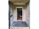 The front door of the home, with stone accents and a wooden entryway leading to the home's interior at 12704 Lacey, New Port Richey, FL 34654