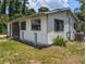 Exterior of the home showing siding and an air conditioning unit surrounded by greenery at 12704 Lacey, New Port Richey, FL 34654