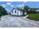 Exterior view of the home showcasing its curb appeal, yard, and a concrete driveway at 12704 Lacey, New Port Richey, FL 34654